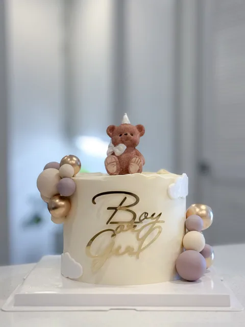 Cream cake with teddy bear, pastel spheres and Boy or Girl sign
