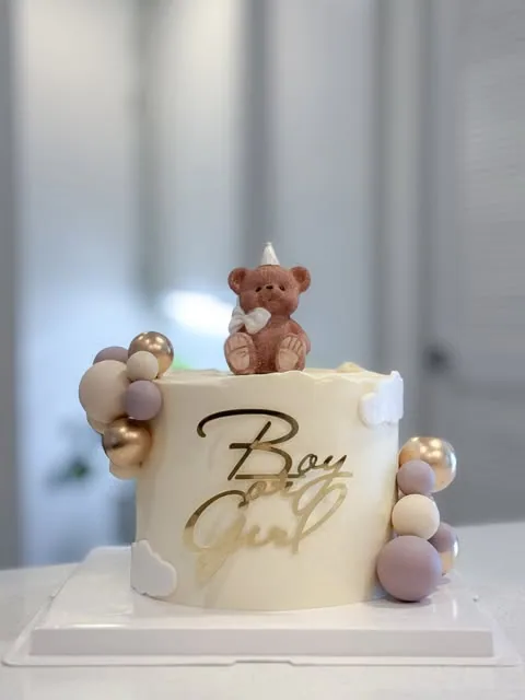 Cream cake with teddy bear, pastel spheres and Boy or Girl sign