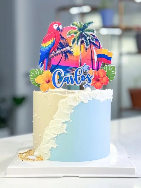 Tropical cake with colourful parrot, palms and Carlos topper