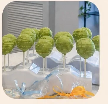 Green cake pops on sticks with pastel ribbons