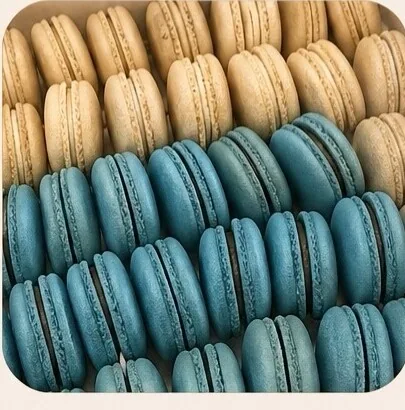 Blue and vanilla macarons arranged in rows